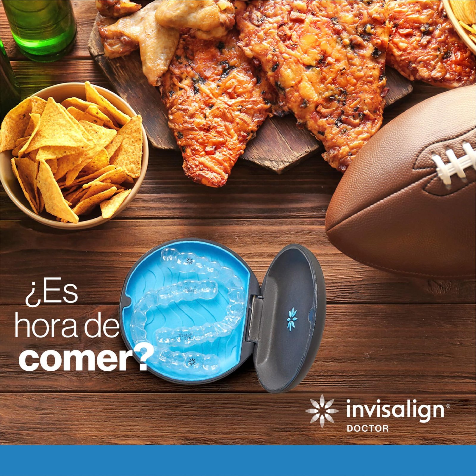 Una mesa llena de comida con chips, cerveza, pizza y un balón de fútbol americano con un estuche y alineadores de invisalign.